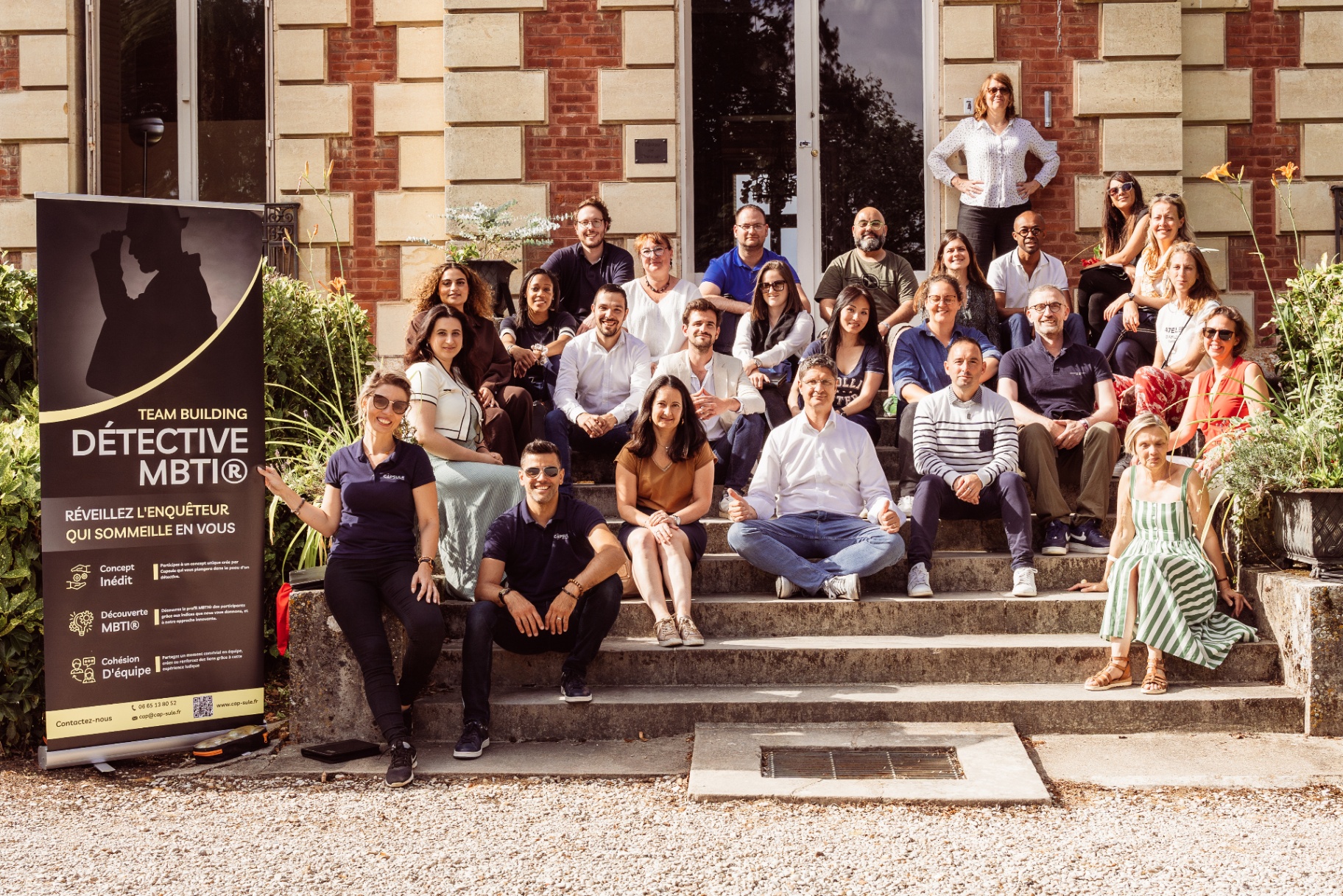 Photo de groupe devant le kakémono Détective MBTI CAPSULE